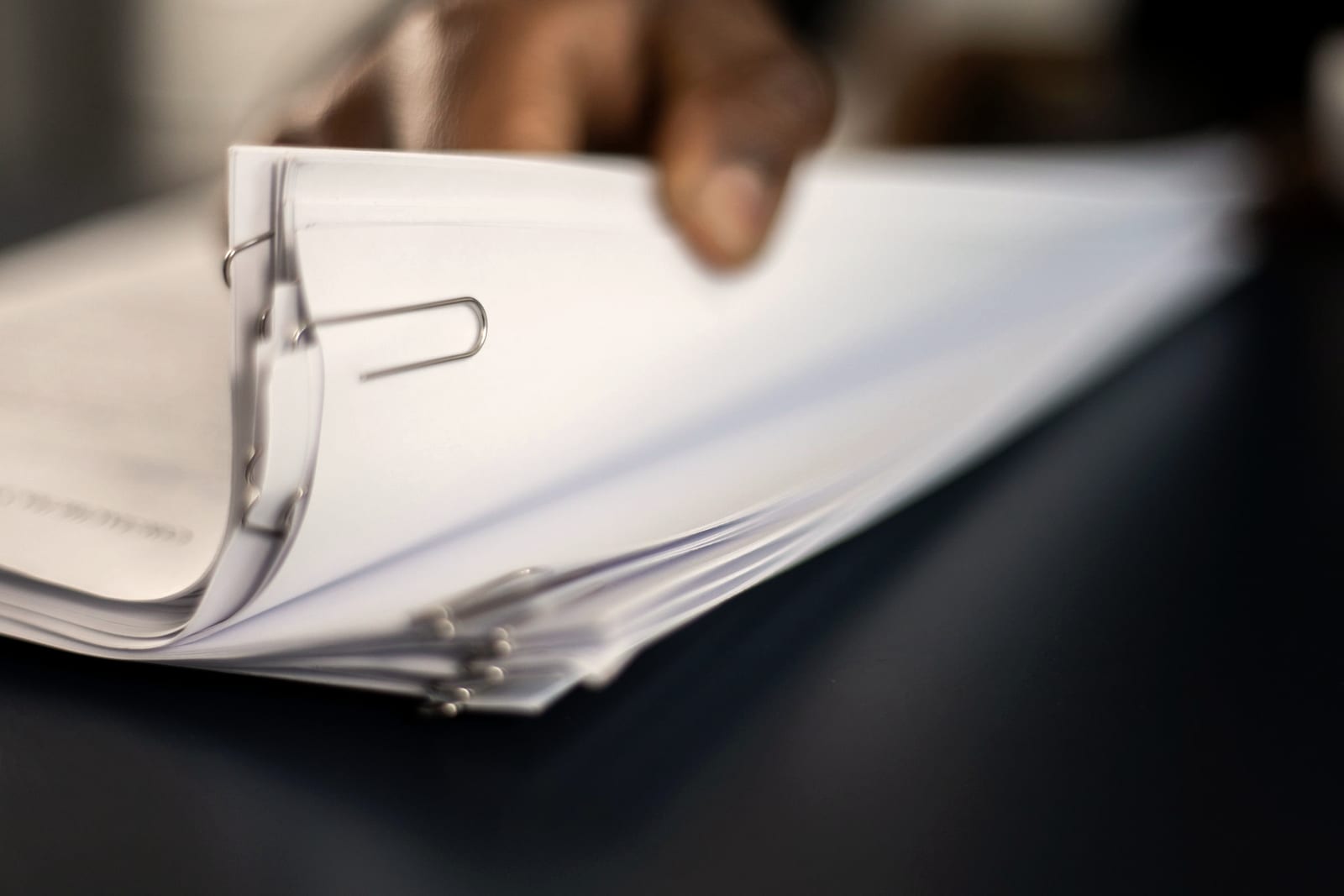 A ring binder of quarterly paperwork