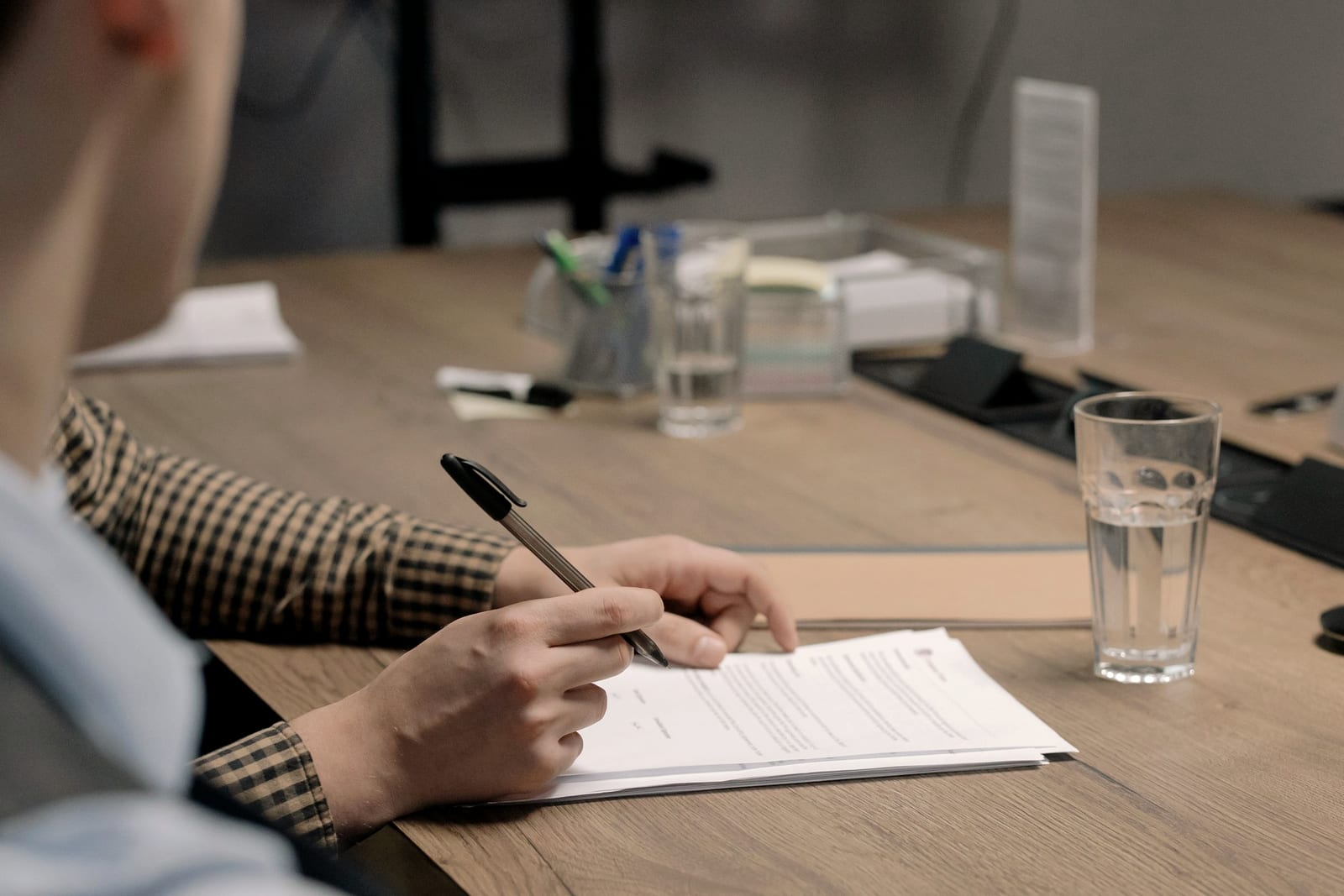 Filling in a form at a desk in morning light